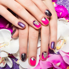 Beautiful colorful manicure with bubbles and crystals on female hand. Close-up. 