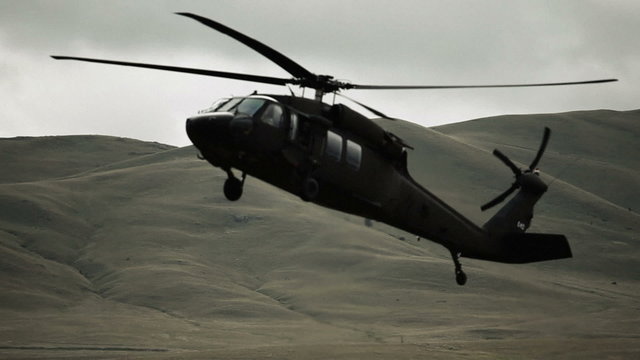 Black hawk helicopter lowering to land