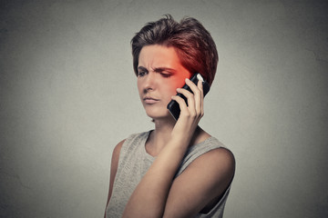girl on the phone with headache. Cellular mobile radiation concept