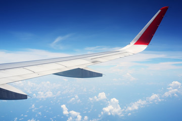 airplane wing against blue sky