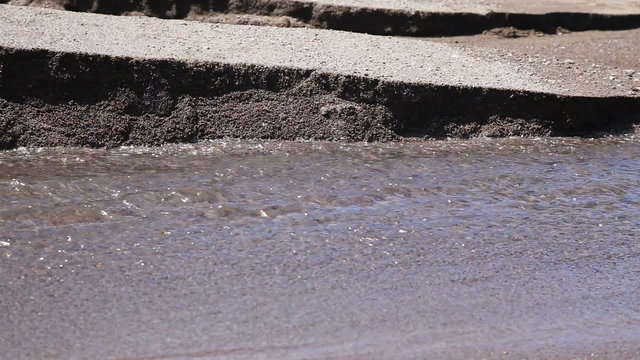 Black sand volcanic beach with creek