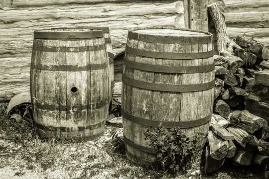 Water Barrels. Weathered and worn vintage water barrels in black and white.