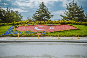 Planted red flowers forming the flag of Turkey in national park in Ankara city 