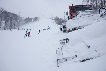 Snow plow alongside a ski run