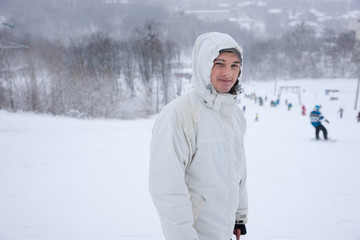 Attractive smiling young man at a winter resort