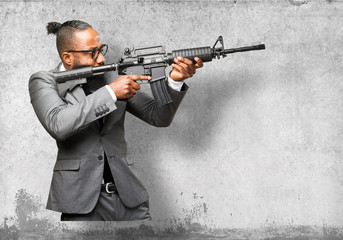 business black man holding a machine gun