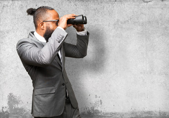 business black man holding binoculars