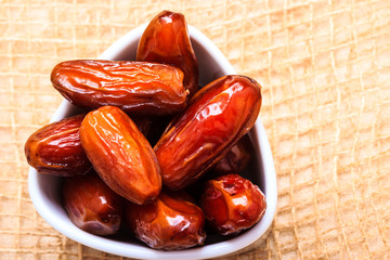dried dates in bowl on table background