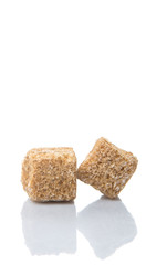 Brown sugarcane sugar cube over white background
