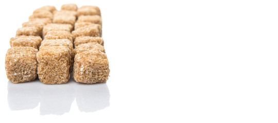 Brown sugarcane sugar cube over white background