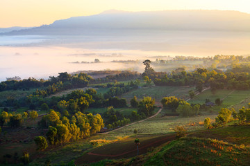 Naklejka premium Misty morning sunrise in Khao Takhian Ngo View Point at Khao-kho