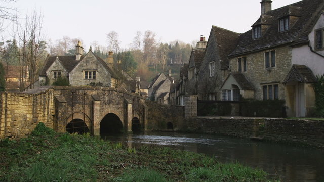 Clip of a bridge over a stream in an old village in England.