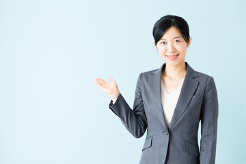 asian businesswoman isolated on blue background