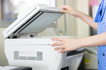 Woman's hand with working Photocopy
