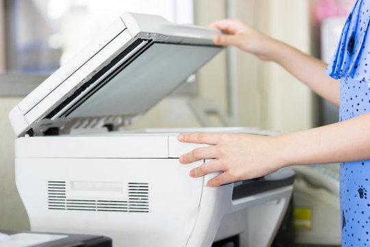 Woman's hand with working Photocopy