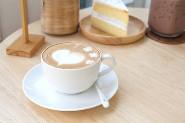 heart symbol on latte coffee cup on table