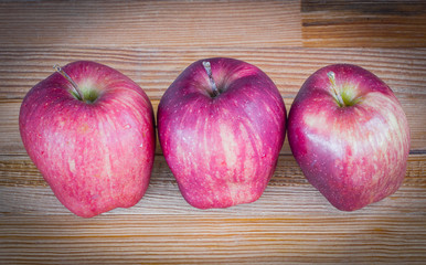 Red apple on wooden background