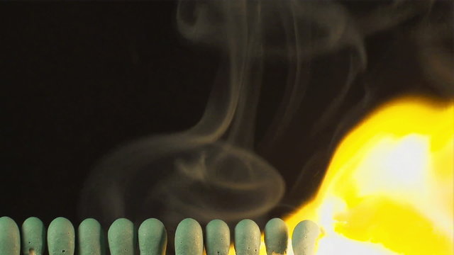 SLOW (240fps): A row of matches are burning in sequence
