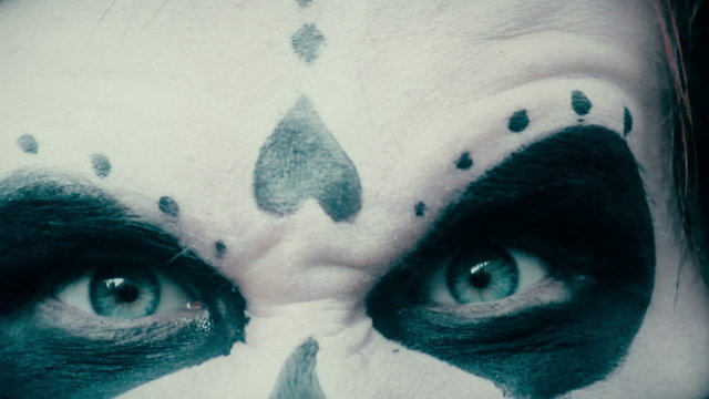 Pantomime actor with scary makeup grimaces at camera, Halloween party, nightmare