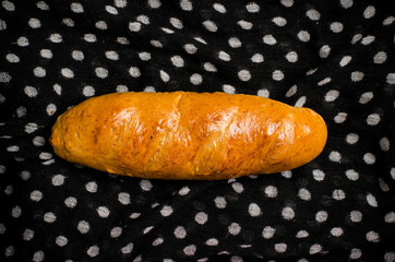 Fresh bread on fabric background