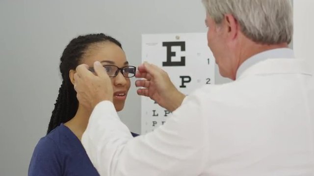 Black woman trying on her new glasses