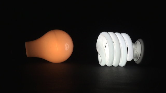 Comparing Incandescent light bulb with Eco fluorescent  light bulb. Incandescent light bulb is already on.
