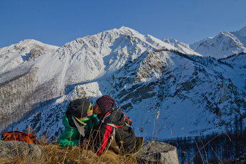 Fototapeta premium Two tourists in the mountains kiss