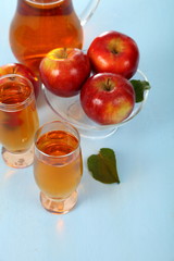 Apple juice and fresh red apples