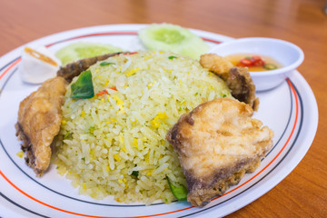 Herb spicy fried rice serve with  deep fried sea bass.