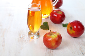 Apple juice and apples on a  wooden table