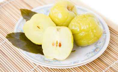 Pickled apples on a plate on white background