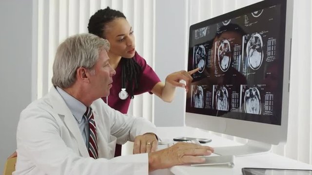 Two doctors reviewing a patient's brain x-ray