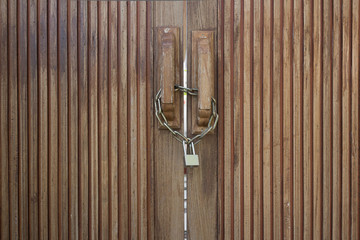 Old wooden doors locked with metal chain