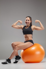 Fototapeta premium The young, beautiful, sports girl doing exercises on a fitball 