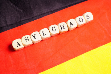 Asylchaos, Buchstabenwürfel auf Deutschlandfahne