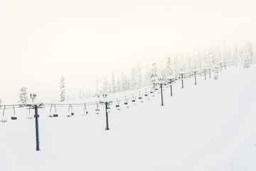 scene of ski lift with seats  over the mountain.