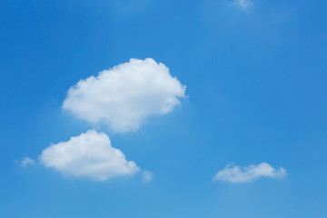 fluffy white cloud floating on clear blue sky background