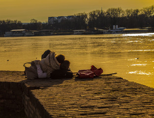 Couple in love on the shore of the river and the sunset