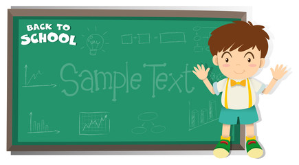 Little boy standing by the blackboard