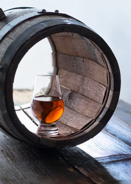 Glass Of Whiskey And A Old Barrel