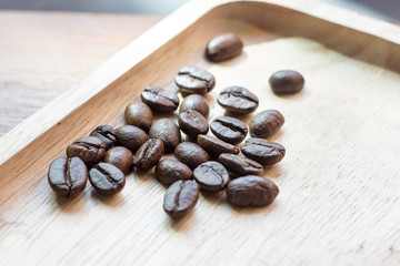 Selective coffee beans prepare for coffee brewing on the wood tray 