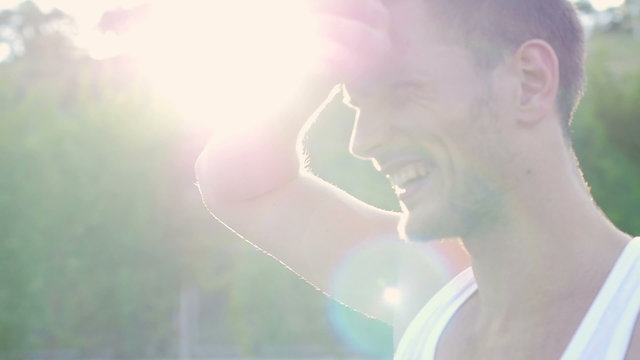 Young Attractive Athlete Wipes Sweat From His Face