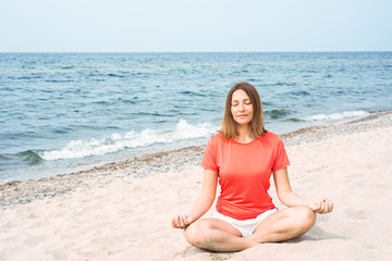Fototapeta na wymiar Woman meditating by the sea