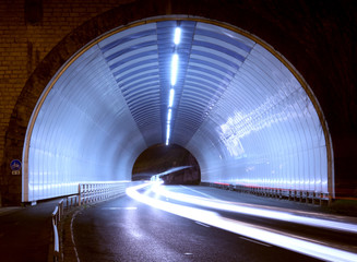 car lights in a tunnel, city at night.