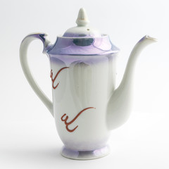 A coffee pot with a dragon pattern