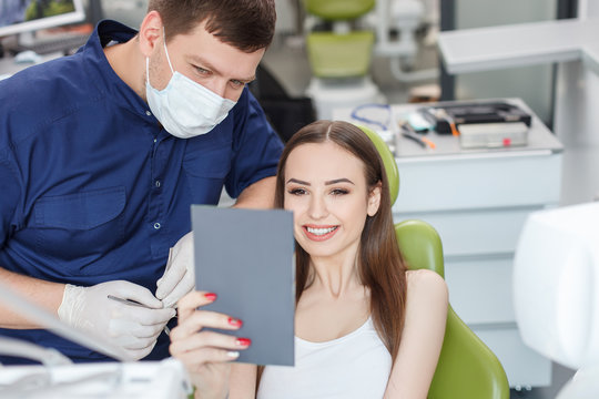 Cheerful healthy woman came to visit dental doctor