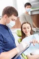 Attractive young woman is visiting a dental doctor