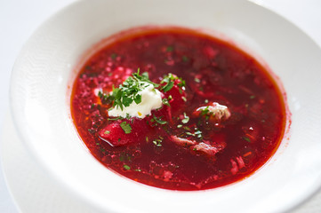 Ukrainian borsch on white plate studio shot