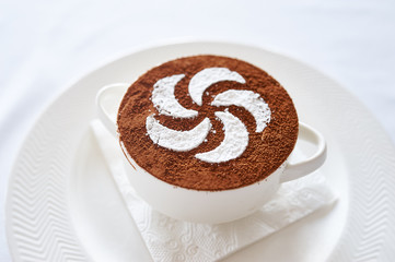 Tiramisu on white plate studio shot