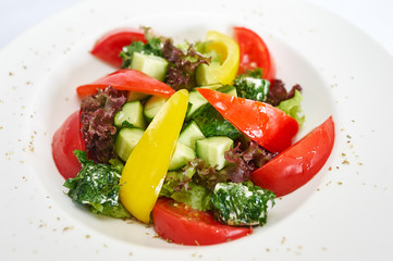 Greek salad on white plate studio shot